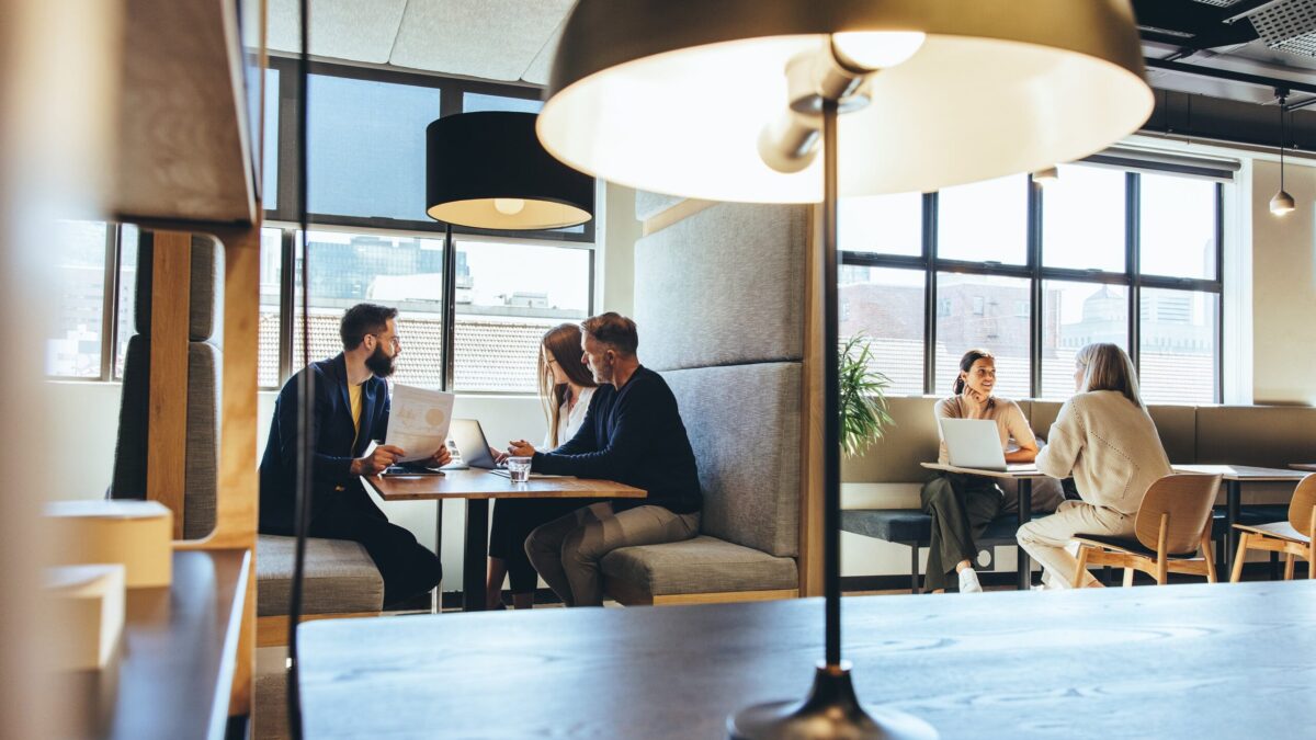 Professionals working in a cosy co-working space.